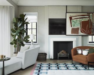 Modern living room with TV behind artwork