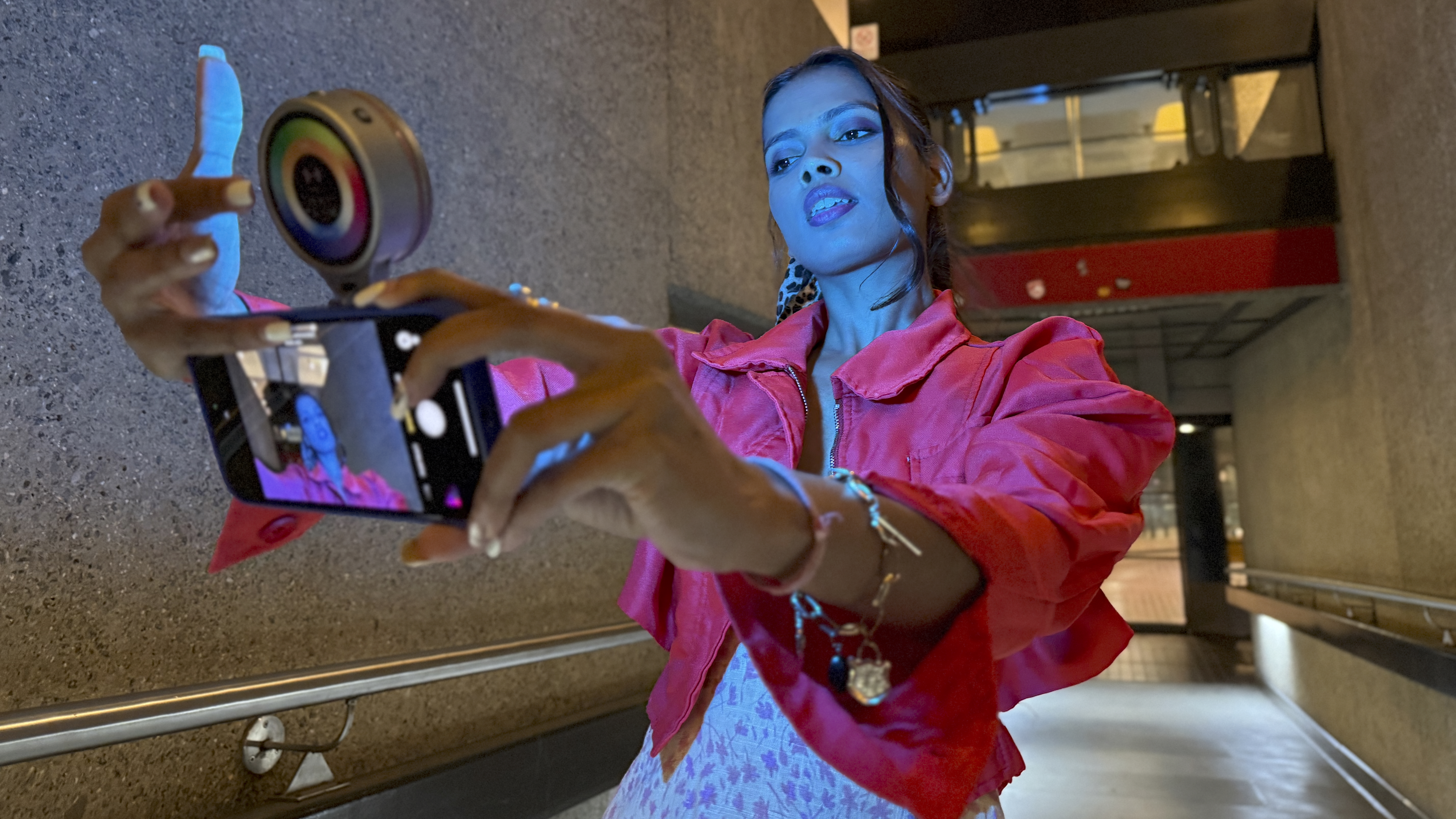A model had the iPhone-mounted Harlowe Sol 5 Spectra at arms length and she stokes the rear panel to adjust the LED colour