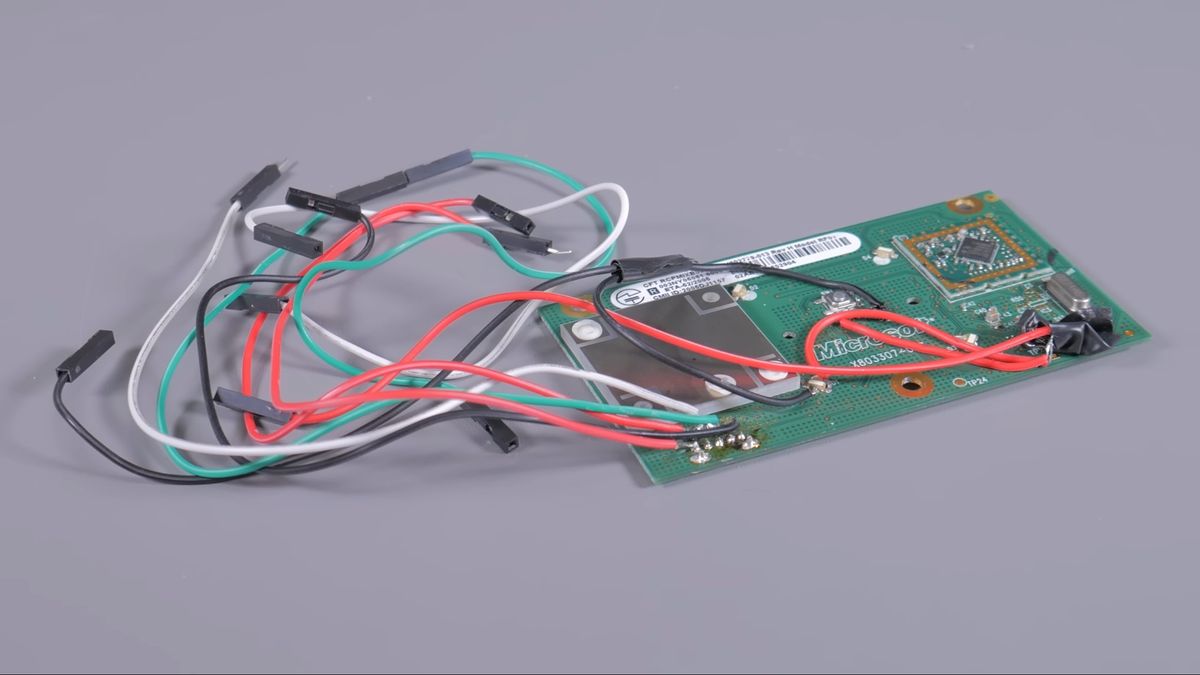Front daughter board of the Xbox 360 modified to work with PC, significant amount of cables drooping from it like a squid's tentacles.