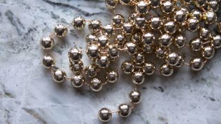 Gold bead garlands on table