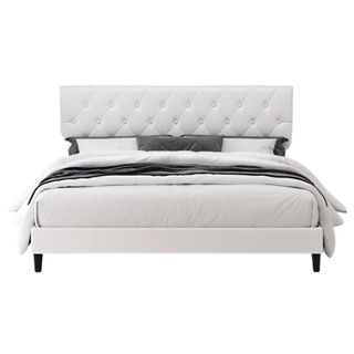 A white faux leather upholstered bed