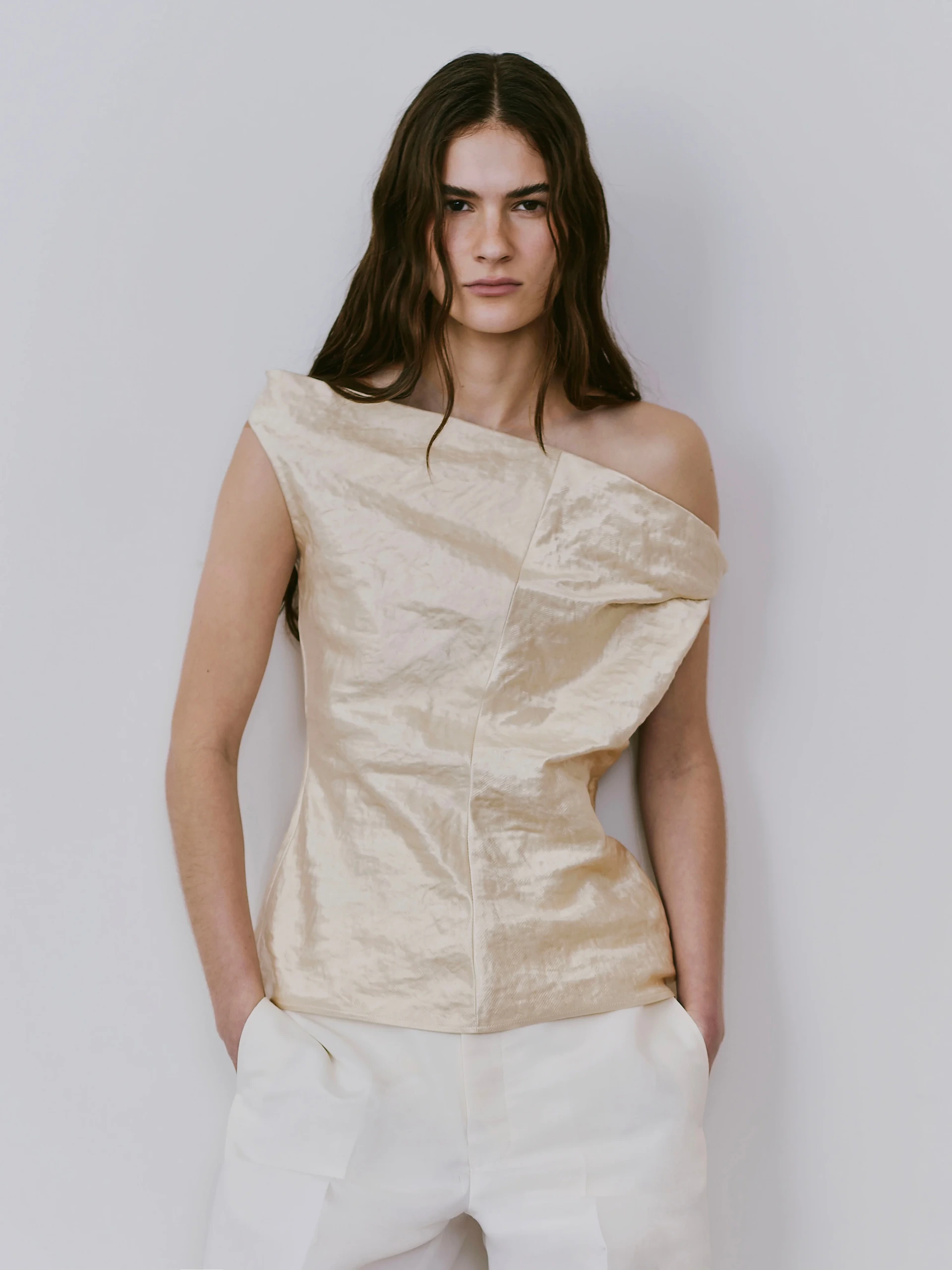 model wearing a crinkled assymetric blouse