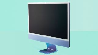 An angled shot of the Apple iMac M1 on a teal background