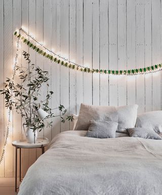 Christmas Bedroom with Chalk Paint walls with fairy lights above a bed - Annie Sloan