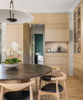 Handleless wood kitchen with a hidden door