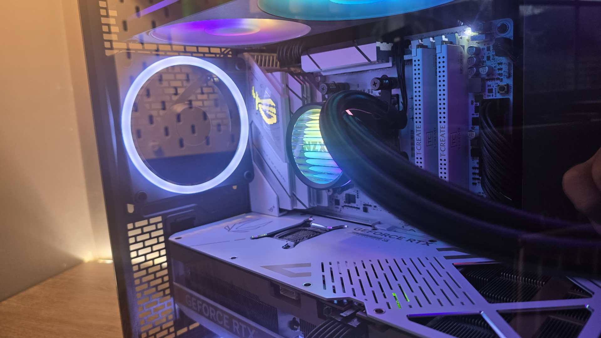 A Phanteks XT V3 PC case on a desk with various PC parts.