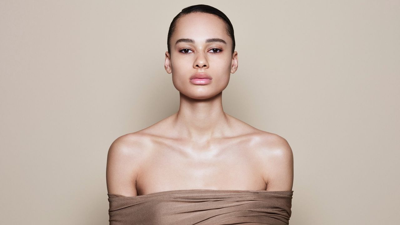 a model wears victoria beckham concealer in front of a plain backdrop