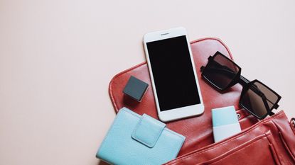 items falling out of handbag to demonstrate bag organizing