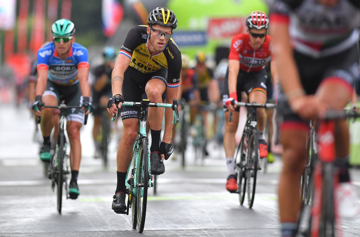 Lars Boom adjusts his shoe over the finish line