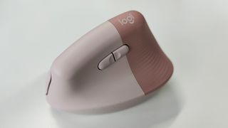 Logitech Lift Vertical Ergonomic Mouse review: pink computer mouse on a desk