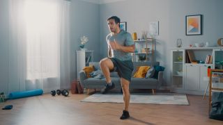 Man performs high knees at home