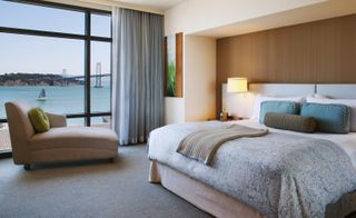 Hotel Vitale guest room with double bed, chair and view of the sea from the window