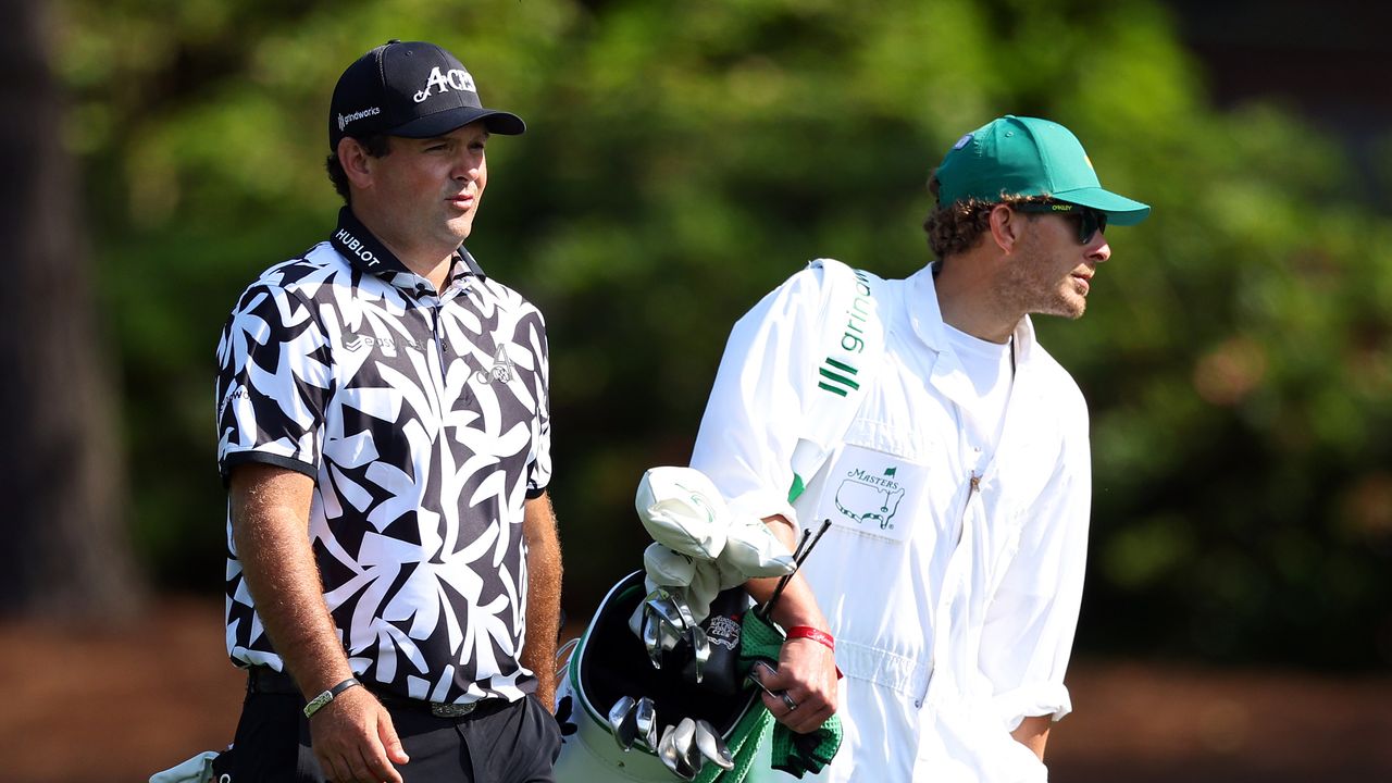 Patrick Reed walks with his caddie in a practice round prior to the 2024 Masters