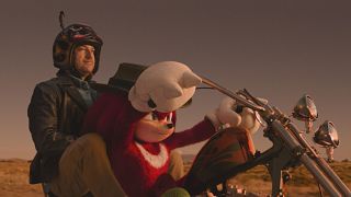 Knuckles and Wade riding a motorcycle in Knuckles