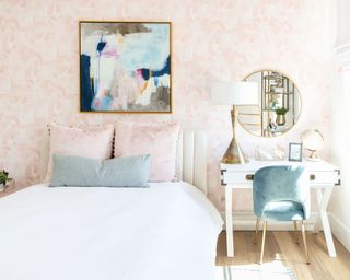 Pink room with large piece of abstract are on the wall
