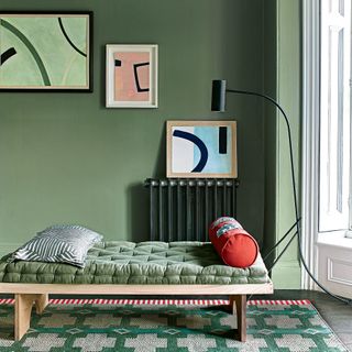 Green living room with black lamp and wooden lounger