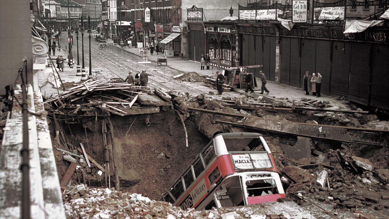 A bus in a large crater in the road ©