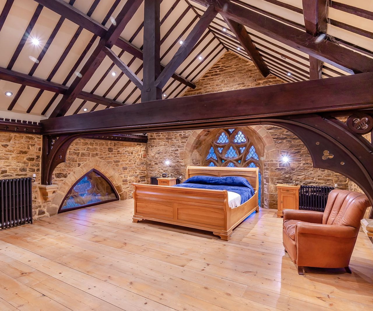A master bedroom with a wooden beam running through the room