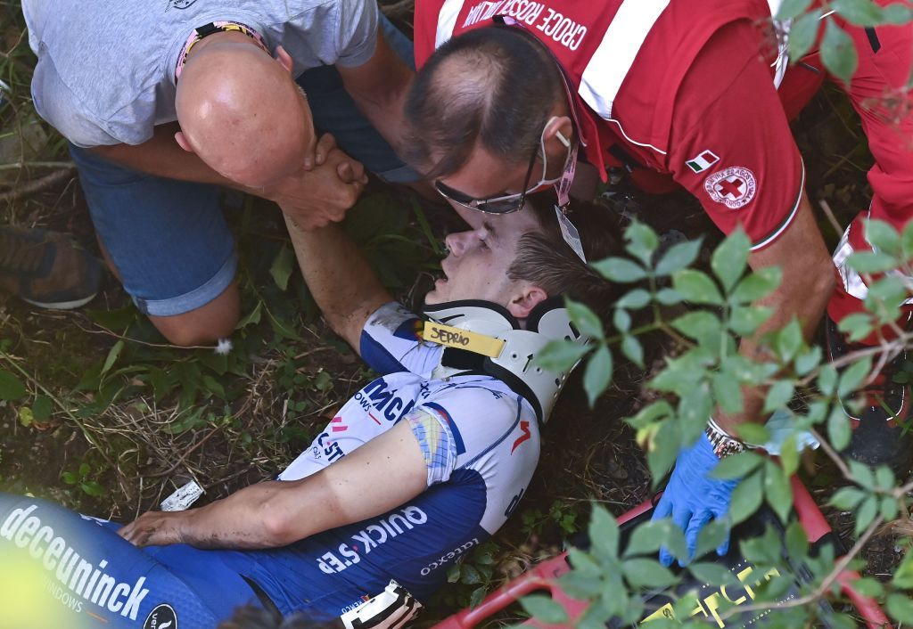 Remco Evenepoel speaks before being put in a stretcher