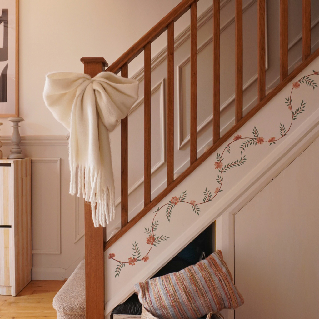 hallway with vine motif painted on the stairs