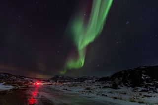 The northern lights seen over a village near the Russian Arctic on Oct. 31, 2021.