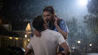 Evie and Danny embrace in the rain in The Couple Next Door episode 2