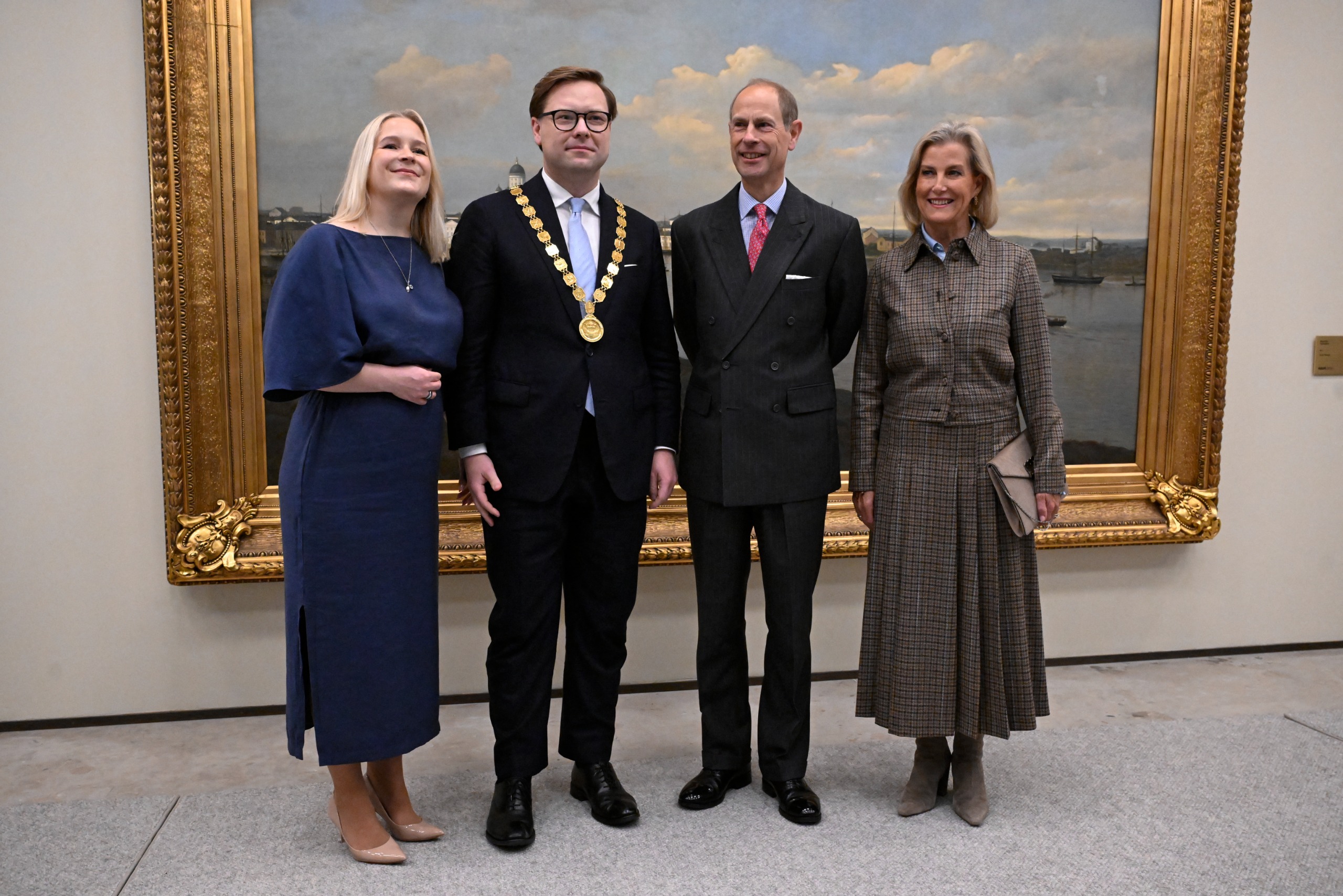 Duchess Sophie and Prince Edward standing in front of a painting with Helsinki Mayor Daniel Sazonov and his wife Anita Westerholm