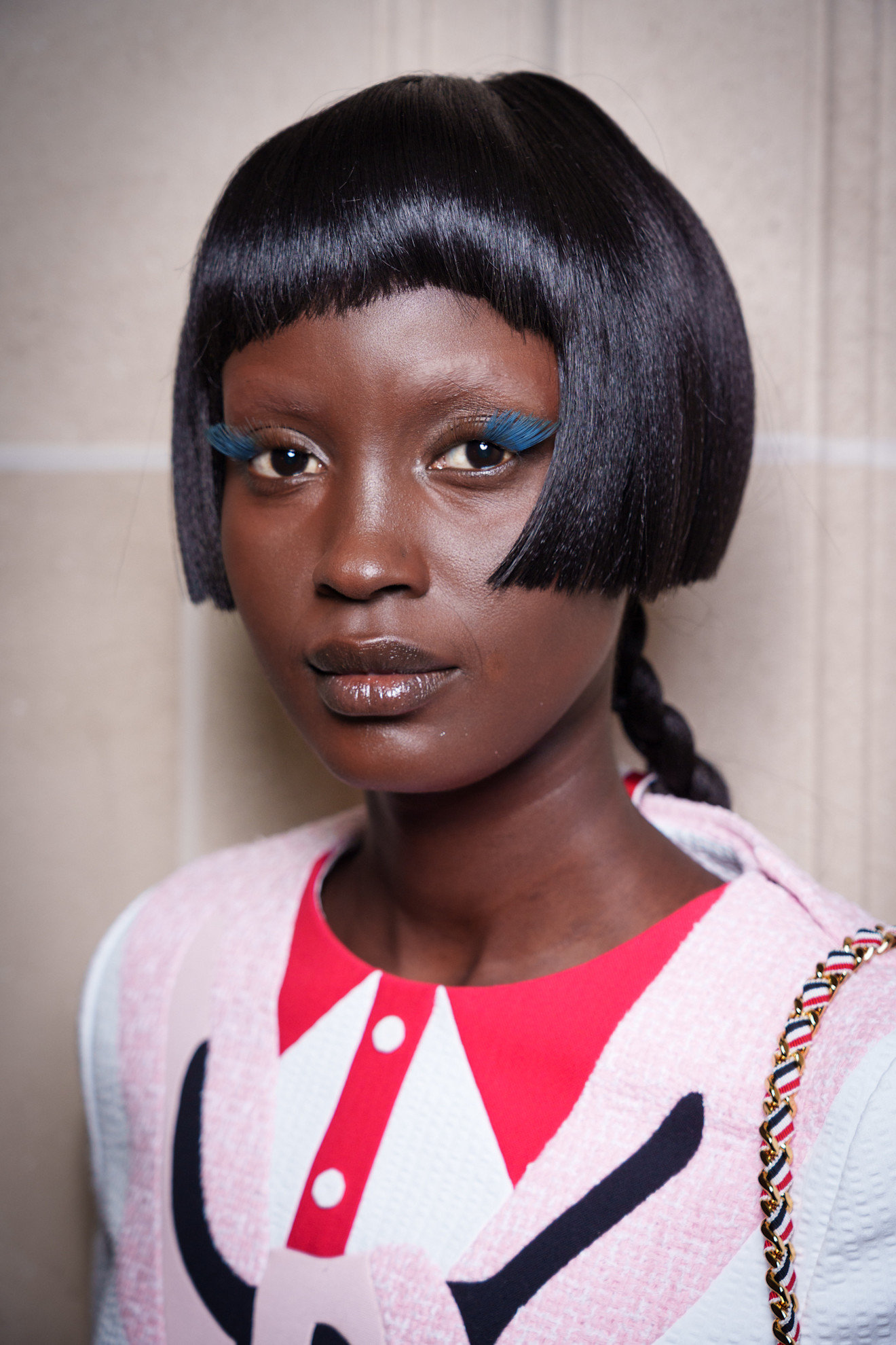 A model at the Thom Browne Spring-Summer 2026 show wearing blue lash extensions.