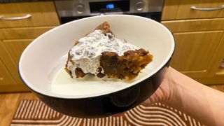 a homemade christmas pudding served with cream