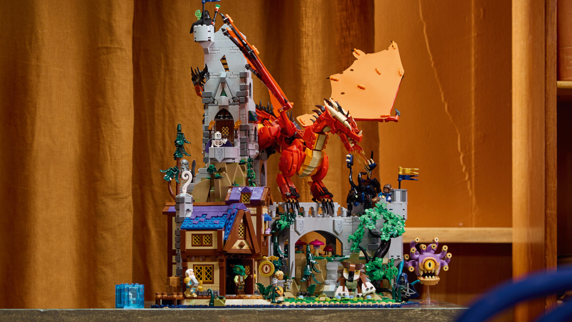The full Lego D&D set on a table, with curtains and a bookshelf in the background