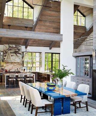 double height dining space with white chairs