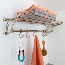Stack of colourful towels on a metal wall mounted towel rack