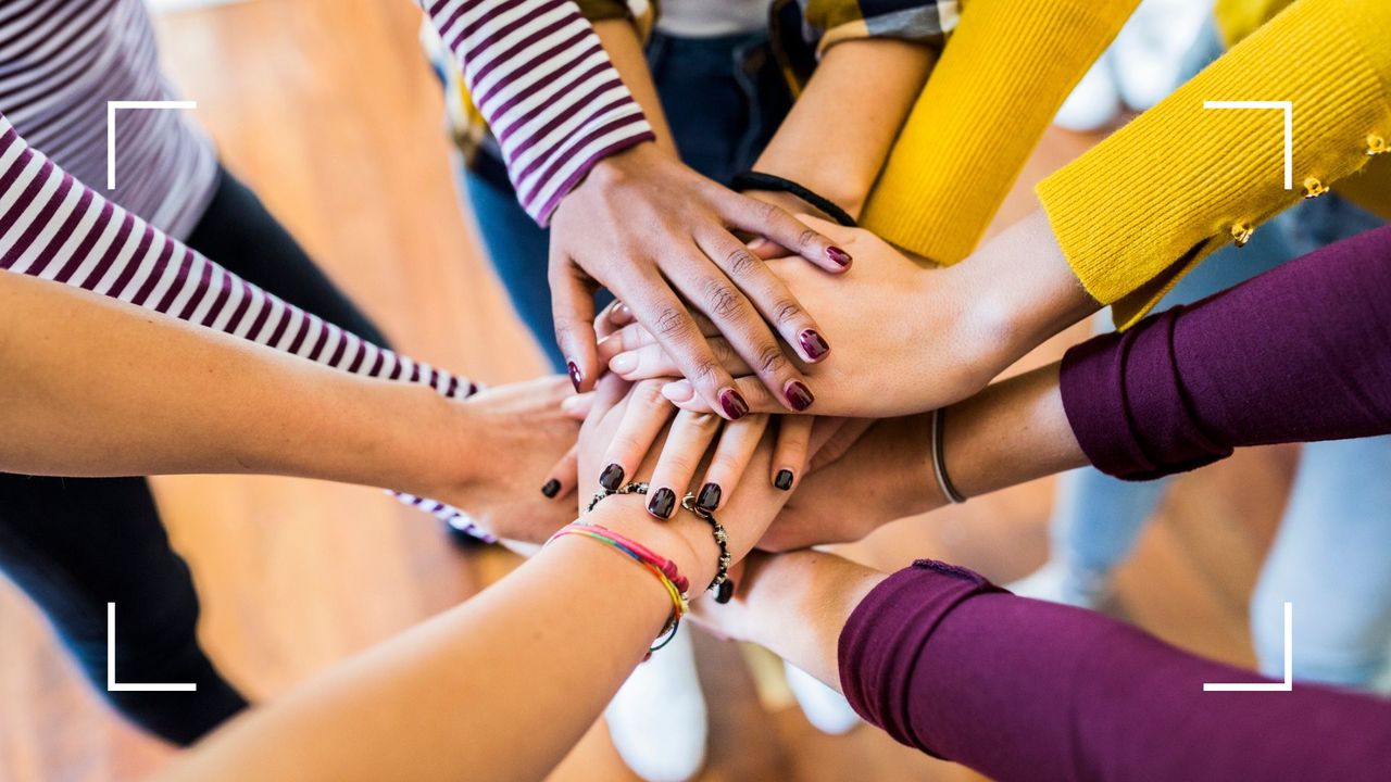 Group of women joining hands