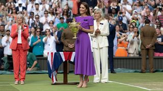 Catherine, Princess of Wales prepares to present the winner's trophy to Spain's Carlos Alcaraz during day fourteen of The Championships Wimbledon 2024