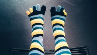 Feet wearing stripey toe socks