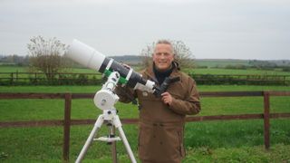 Jules Hudson in a field with a telescope in Winter on the Farm.