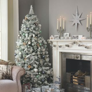 christmas tree with white and green deco in grey room