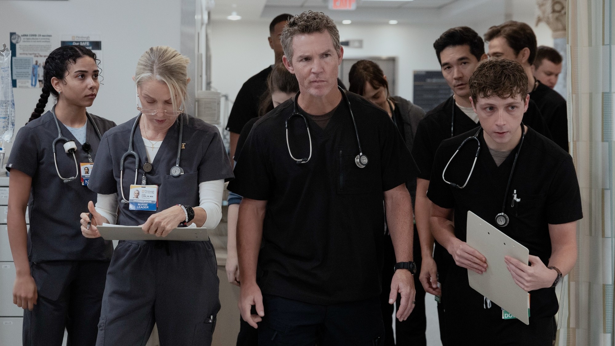 From left to right: Emma, Dana, Abbot, Shen and Whitaker walking in The Pitt. 