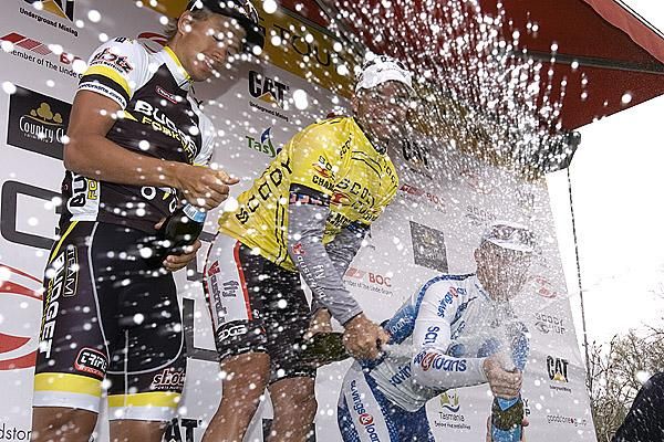 Champagne shower for a snapper: Joel Pearson (far right) of Savings and Loans makes the most of having a photographer at close range during the presentations in Westbury.
