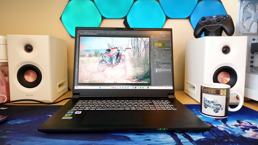 A black Overclockers Pinnacle laptop on a wooden desk