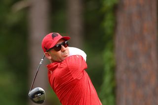 Sergio Garcia strikes a tee shot with sunglasses on