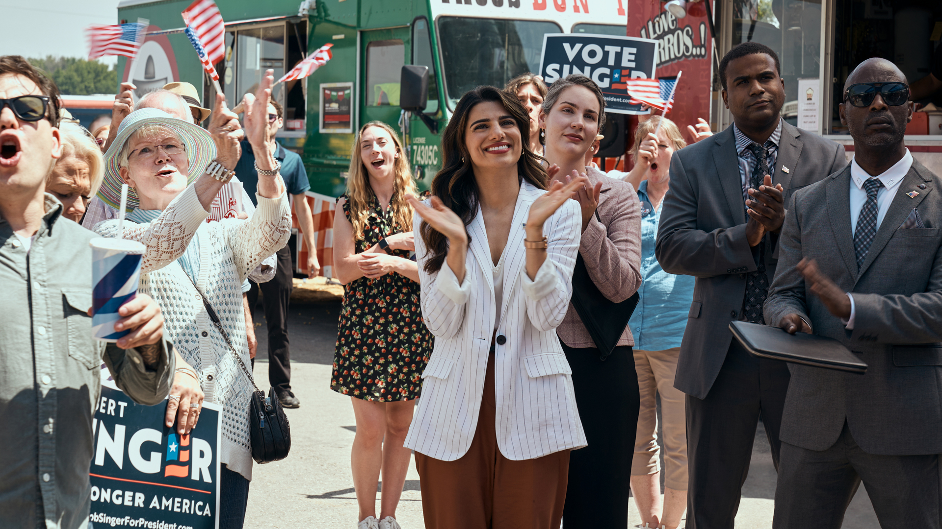 Victoria Neuman claps alongside some of her supporters at a rally in The Boys season 3