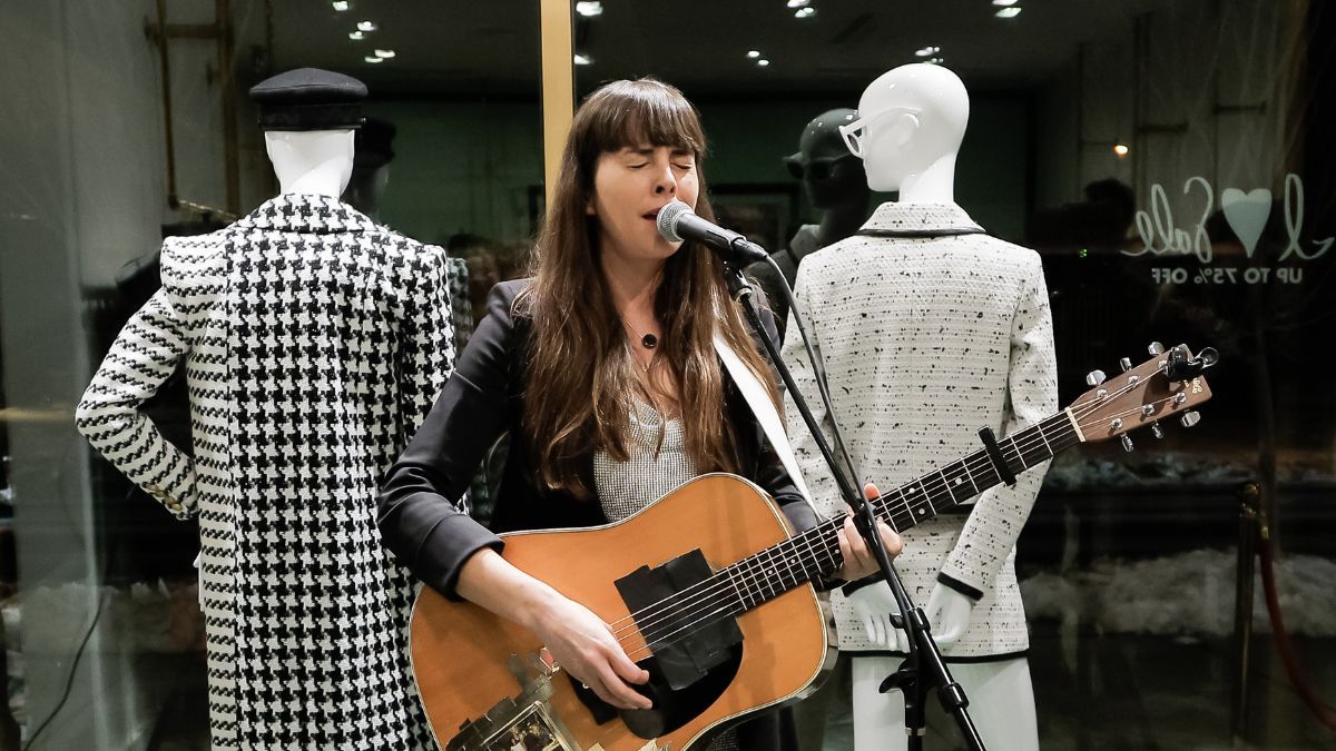 Madi Diaz playing her Martin D-28 guitar at event