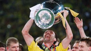 Borussia Dortmund's Juergen Kohler holds the trophy after his team won the 1996-1997 UEFA Champions League final against Juventus 3-1. (Photo by Christian Liewig/TempSport/Corbis via Getty Images)