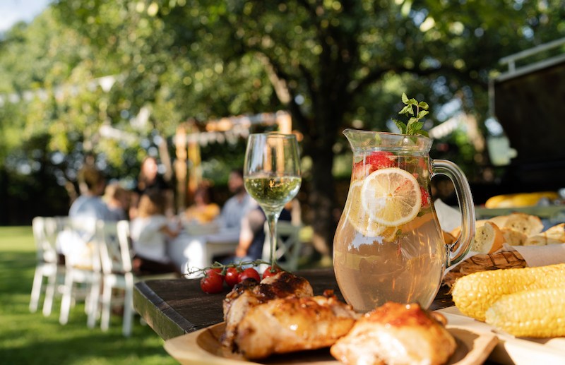Food on table set outdoors for celebrating birthday, garden party concept.
