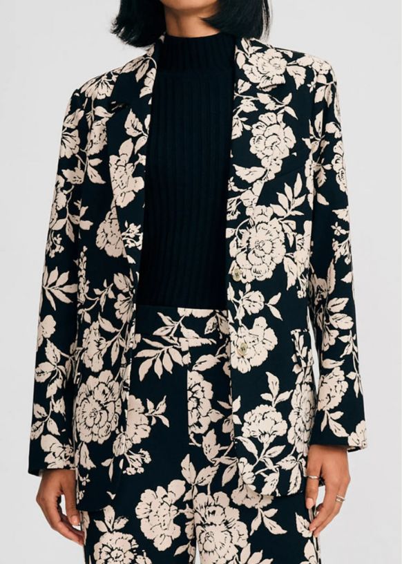 Image of woman wearing black and floral blazer