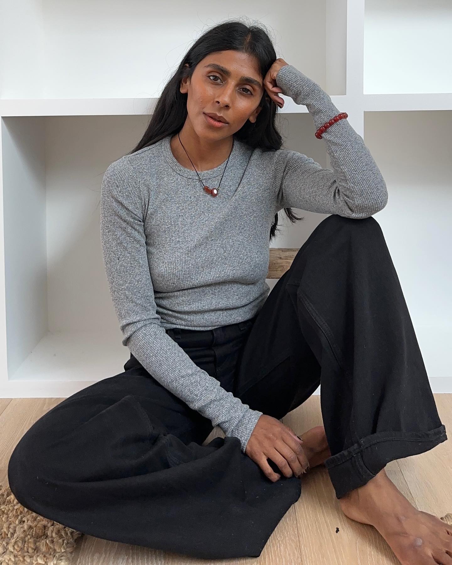 An image of @monikh wearing a ribbed top, one of the best long-sleeved tops for women.