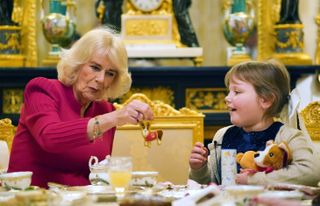 Queen Camilla with Olivia Taylor, a young girl with a brain tumour