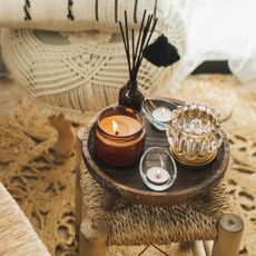 Cosy interior shot showing candle and diffuser on small table