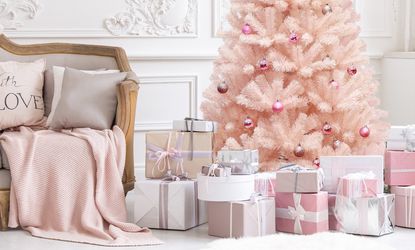 pink Christmas decorations in a pretty living room with a pink Christmas tree and pink presents 